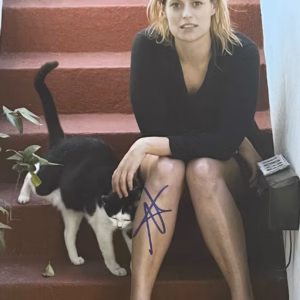 Marianna Palka GLOW Signed Photo Marianna Palka GLOW signed photo: 10x8 color candid on red stairs with cat, blue ink on leg, COA included