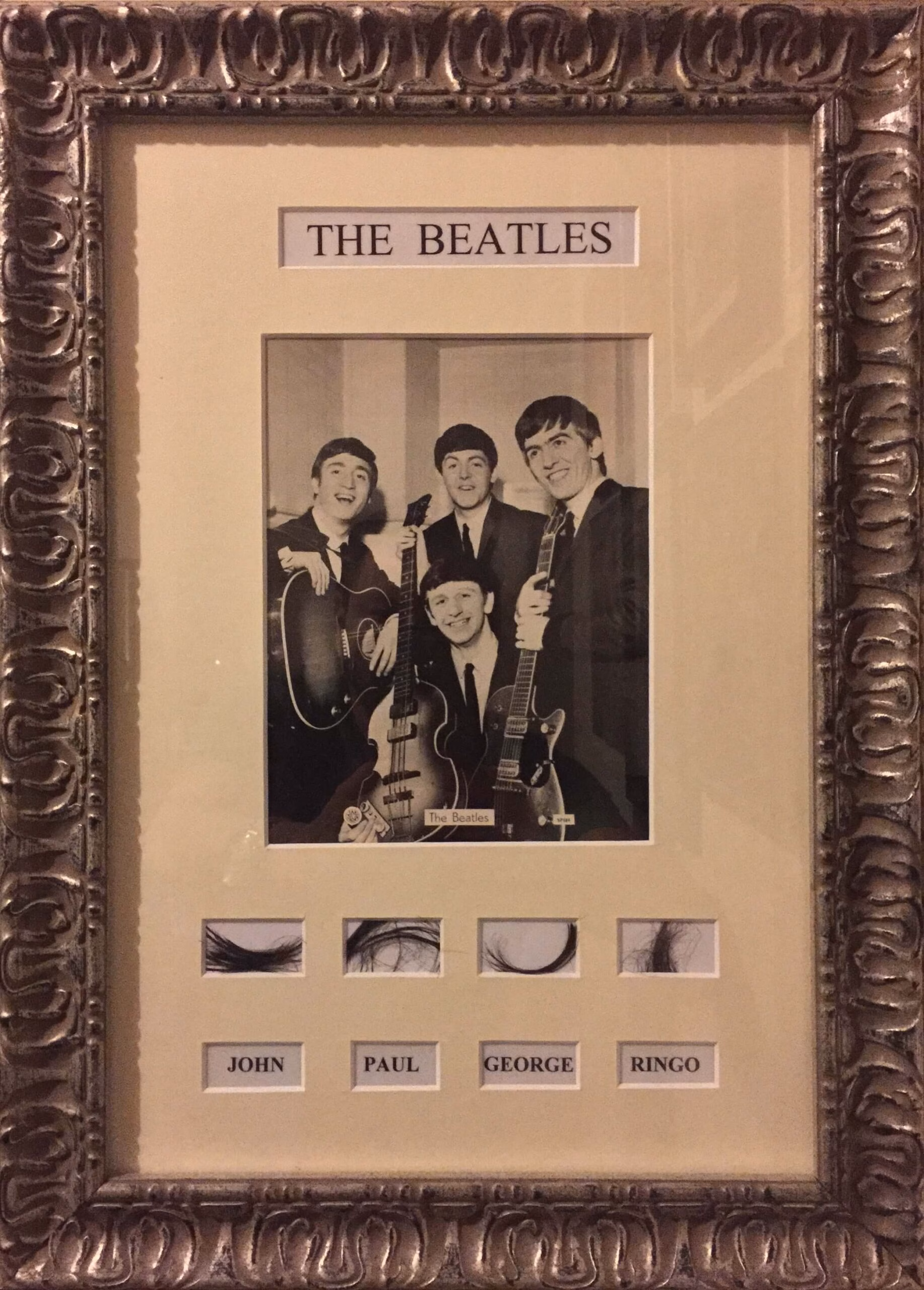 The Beatles Hair Collection framed display showing four labelled cards with hair from John, Paul, George and Ringo, COAs, trackable delivery.