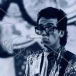 Elvis Costello Autograph on 8x10 black and white late‑1970s style promo photo with silver ink signature and COA from Presley Collectibles.