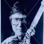 Hank Marvin Signed Photo 8x10 black‑and‑white studio guitar portrait with black ink “Best Wishes” inscription and COA from Presley Collectibles.