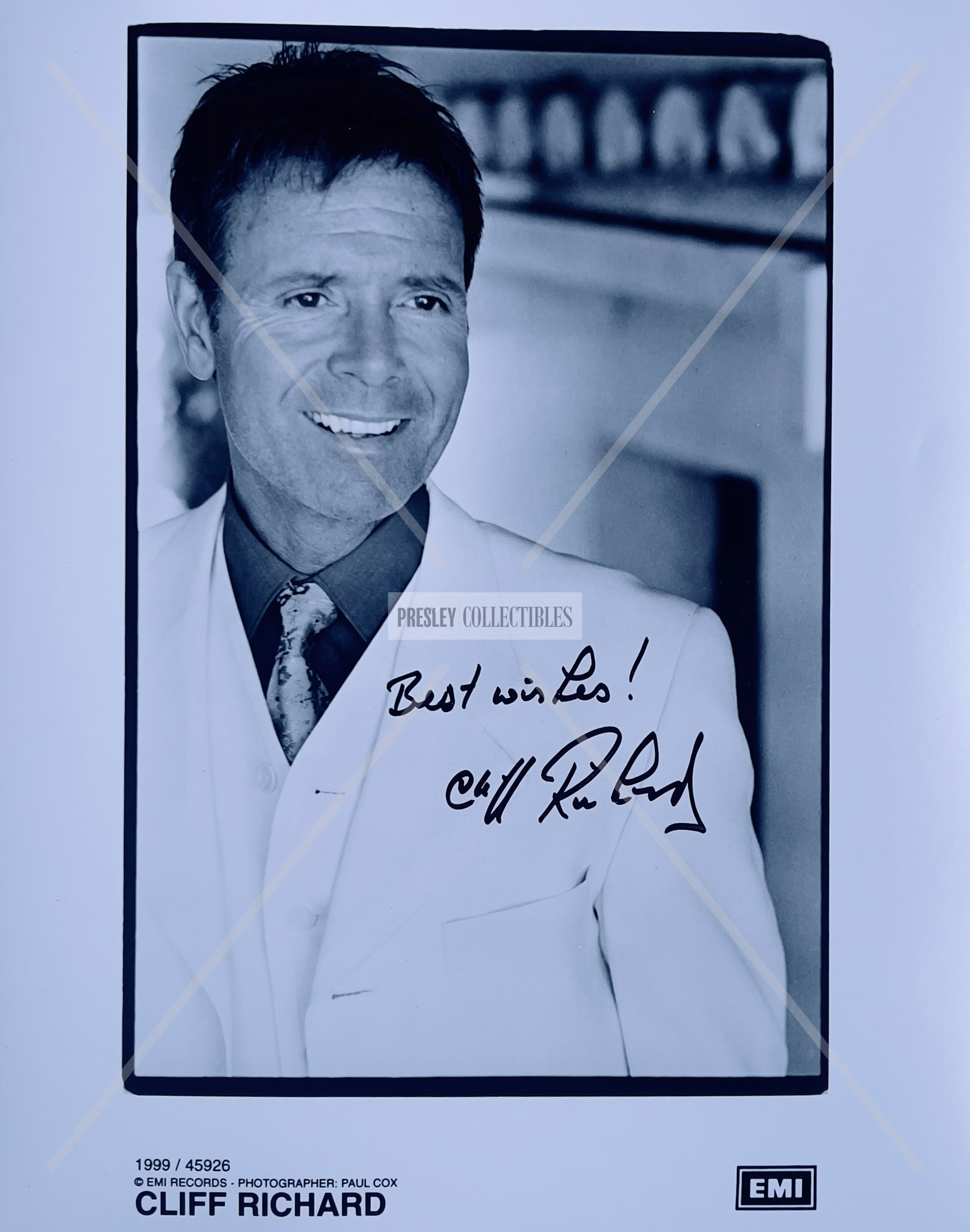 Cliff Richard Autographed Promo Photo 8x10 Paul Cox EMI black‑and‑white portrait with black ink “Best wishes!” signature and COA from Presley Collectibles.
