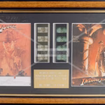 Indiana Jones Double Film Cells — Limited edition dual-film cell display, No. 40 of 500, featuring original 35mm film from Raiders of the Lost Ark (1981) and Indiana Jones and the Temple of Doom (1984). Dark wood and gold frame, Perspex-glazed, excellent condition, 14.5" x 9". Original Rye by Post Certificate of Authenticity affixed to reverse.