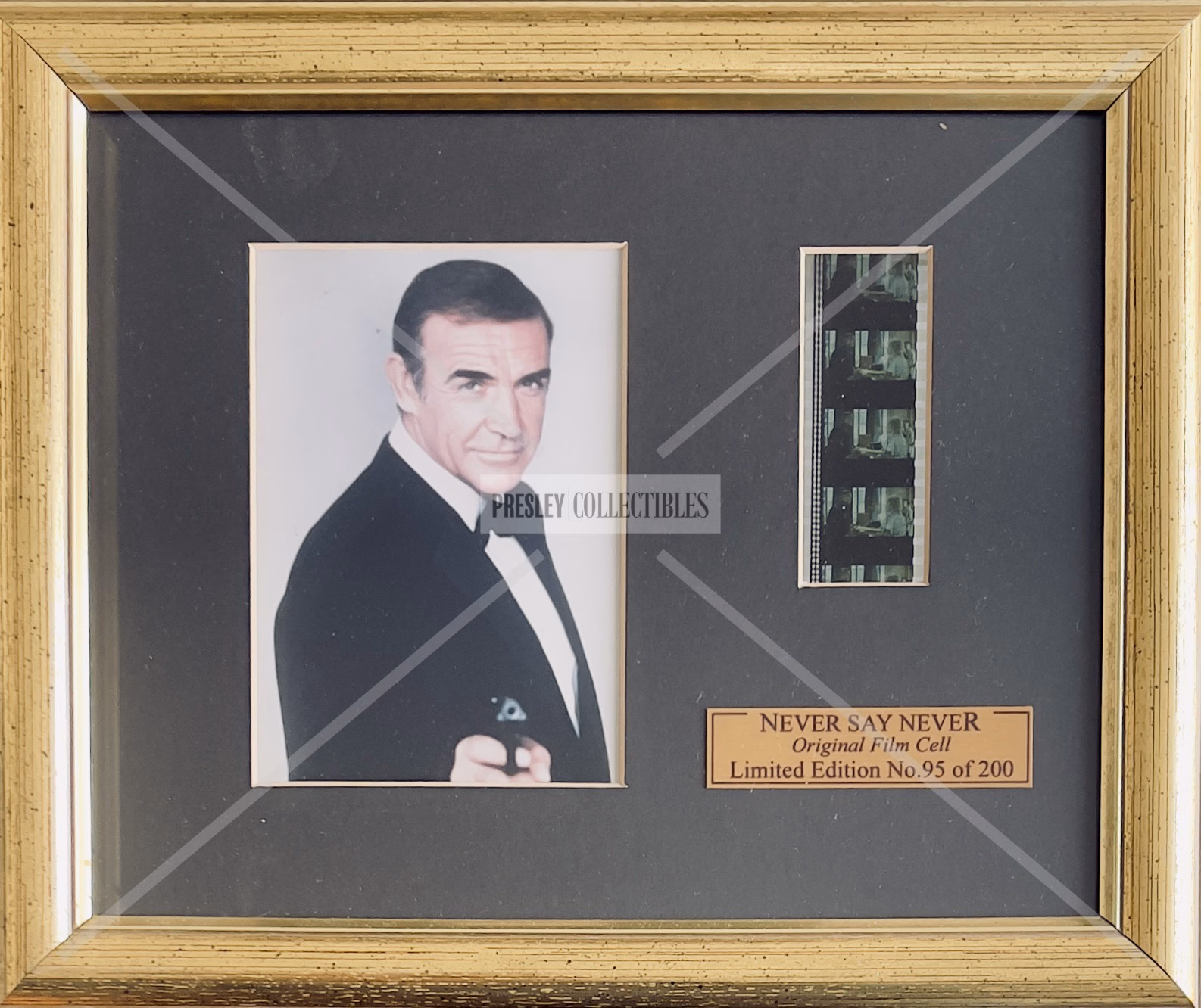 Never Say Never Display — Original 35mm film cell limited edition display from Never Say Never Again (1983), No. 95 of 200. Featuring Sean Connery as James Bond. Gold-framed, Perspex-glazed, very good condition, 12" x 10". Original Certificate of Authenticity affixed to reverse.